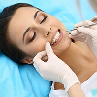 Woman receiving periodontal maintenance treatment
