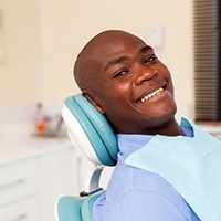 A man smiling at his dental appointment.