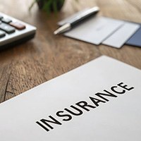 Insurance document next to calculator