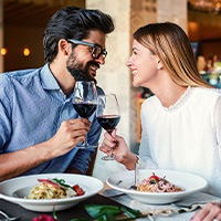 Couple smiling at each other on date in restaurant
