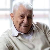 Older man with dentures in Covington smiling inside