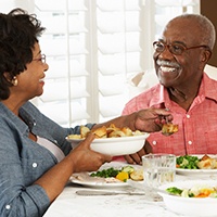 Older couple enjoying the benefits of dental implants in Covington