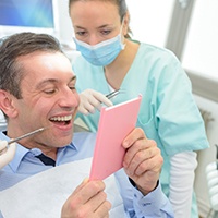 Patient examining their dental implants in Covington with a dentist