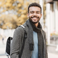 Man with dental implants in Covington, GA smiling and walking outside