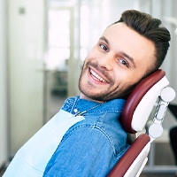 Male dental patient with dental implants in Covington, GA sitting in dental chair
