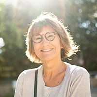 Senior woman with glasses walking outside