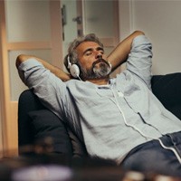 Man relaxing at home on sofa