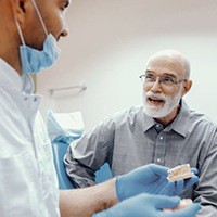 A patient speaking to a dentist about dental implants