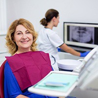 A woman smiling in a dental chair