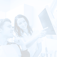 Patient and dental team member looking at x-rays