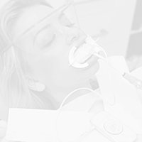 Patient using Glo teeth whitening system