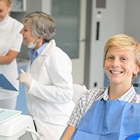 Teenage boy smiling while sitting in treatment chair