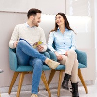 Couple smiling at each other in waiting room