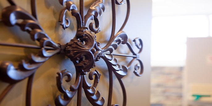 Dental office door with decorative iron flower