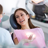 a patient smiling at her sedation dentist in Covington