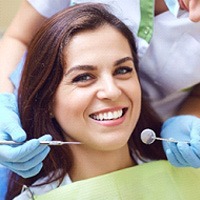 Woman with brown hair smiling during dental checkup