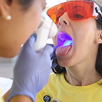 Dentist performing oral cancer screening