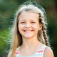 Young girl sharing healthy smile after children's dentistry