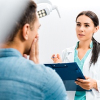 Patient and dental team member discussing cost of root canal therapy