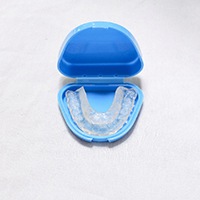 Occlusal splint to treat TMD, stored in blue case