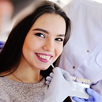 Woman smiling at cosmetic dentist in Covington during veneers consultation