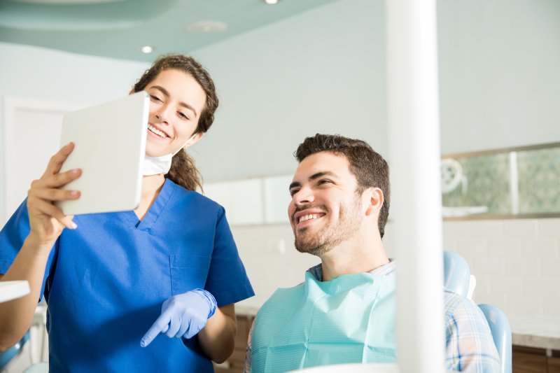 man discussing gum disease in Covington with his dentist