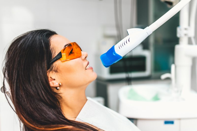 A woman receiving professional teeth whitening