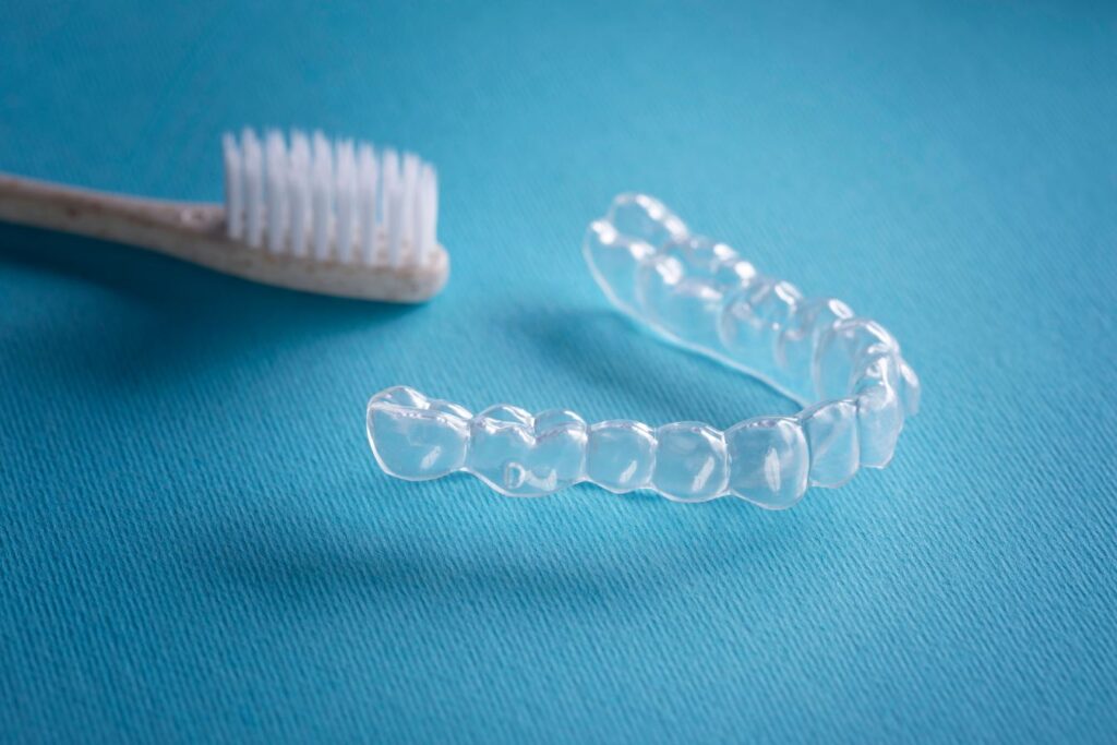 A clear aligner and a toothbrush